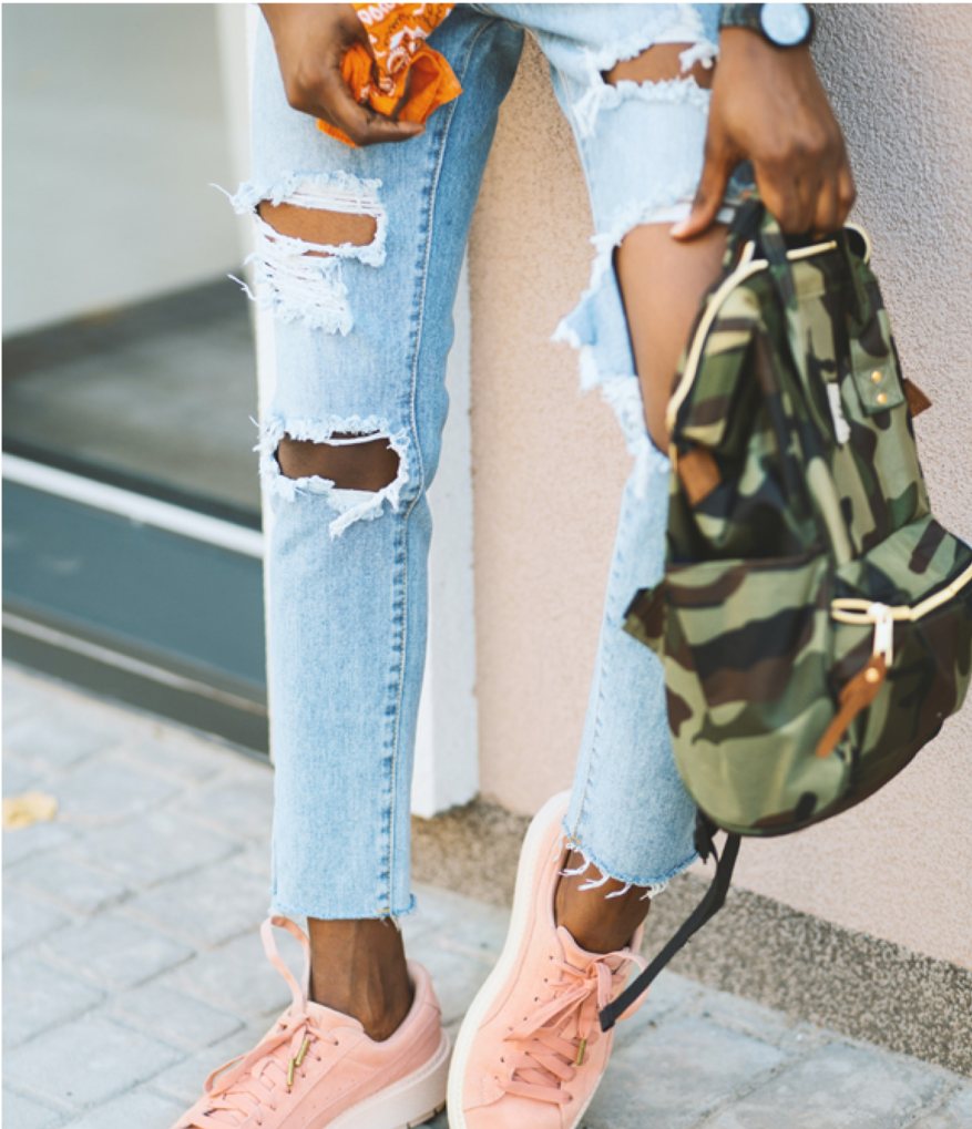 Close-up of ripped jeans and sneakers