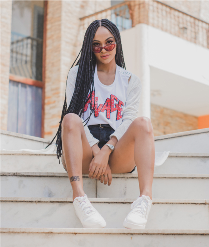 Woman in white outfit sitting on steps